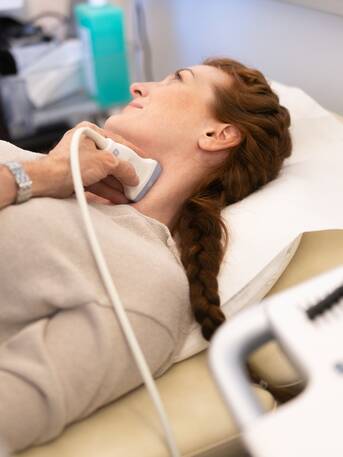 Woman lying down during carotid artery ultrasound examination